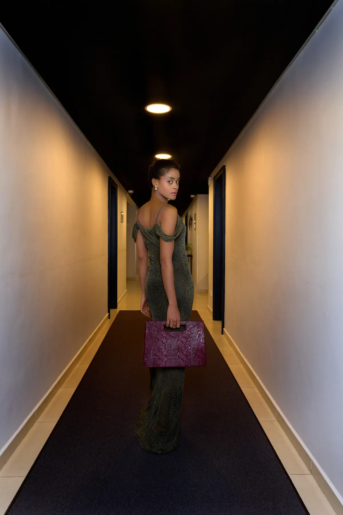 Guest returning through a quiet Nordic Hotel Lagos corridor